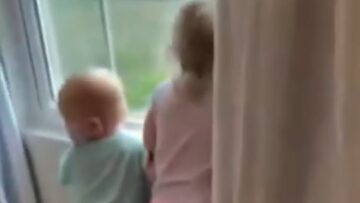 Joyful-Toddlers-Eagerly-Anticipate-Mommys-Return-by-the-Window.jpg