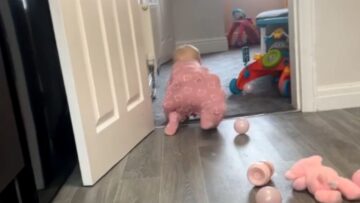 Baby-girl-unfazed-by-ball-pit-balls-in-adorable-babygrow.jpg