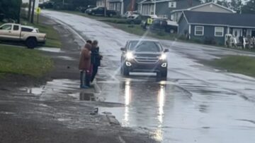 Kids-thrilled-by-puddle-splashes-from-passing-car-Adorable.jpg